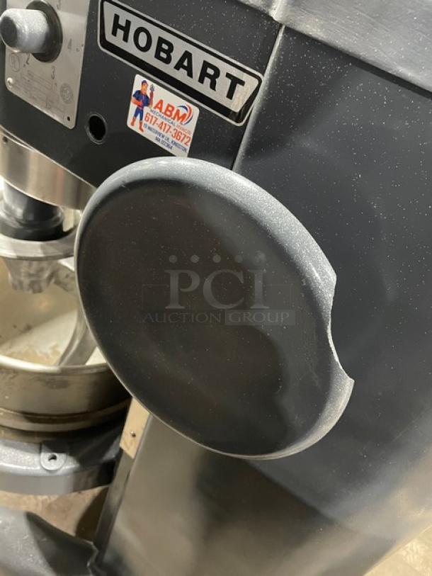 Hobart H600T 60 Qt. Planetary Dough Mixer in charcoal gray, with bowl and dough hook. Visible Hobart branding, 220V, 3-phase.