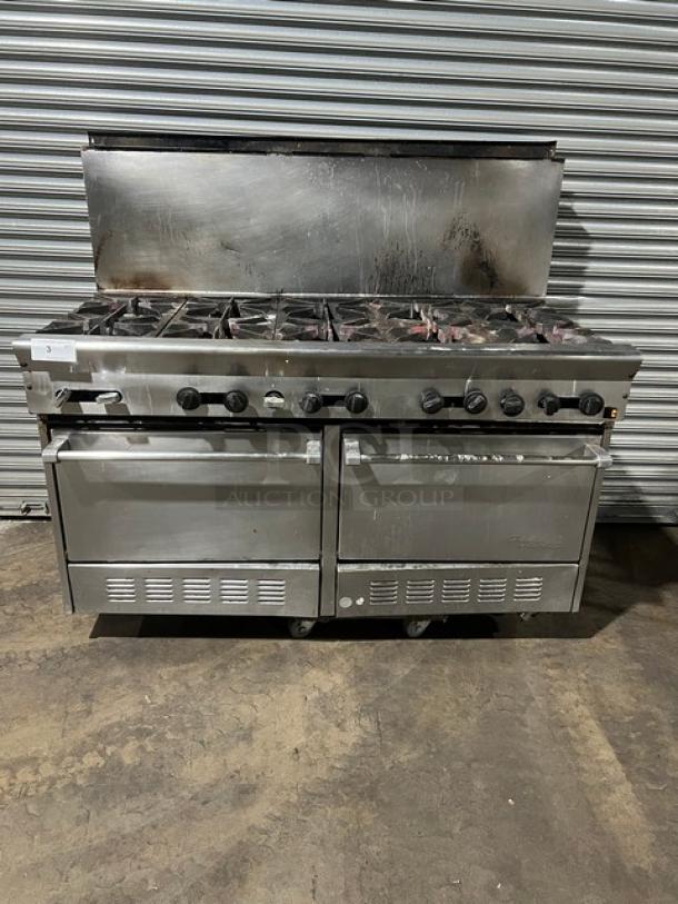 U.S. Range stainless steel 10-burner gas range with double oven, backsplash, and wired oven rack. Pre-owned condition.