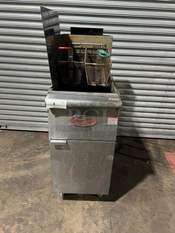 Avantco FF300N stainless steel deep fat fryer, natural gas, 2019 model. Includes basket hanger, fry baskets, left-side and back splash, on legs. Serial number: 19110822VA. Signs of use visible.