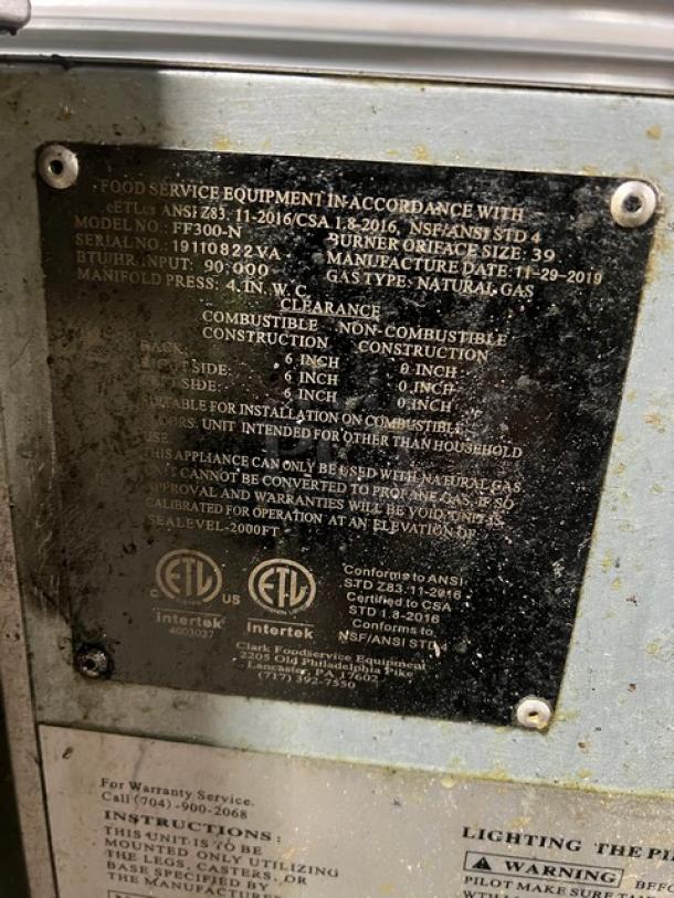 Avantco FF300N stainless steel natural gas fryer, 2019 model, with left-side and back splash. Includes basket hanger, fry basket, on legs. Serial: 19110822VA.