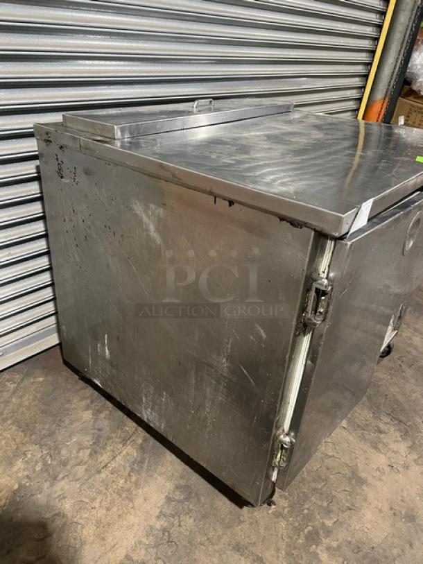 Commercial stainless steel refrigerated salad/sandwich prep table, 1-1/2 door, with poly coated wired rack, on casters, used condition.