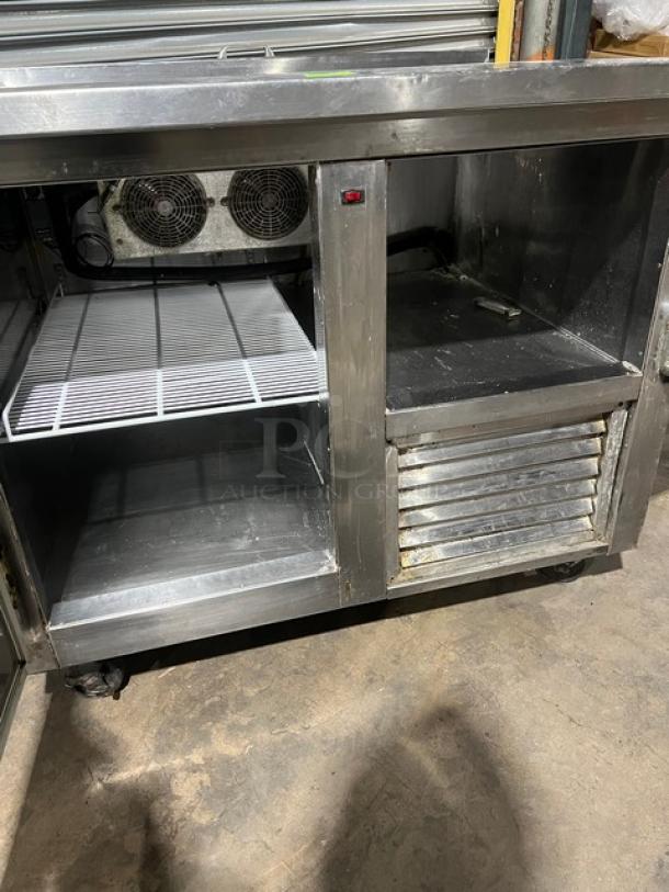 Commercial stainless steel refrigerated salad/sandwich prep table with 1-1/2 doors, poly coated wire rack, and casters.