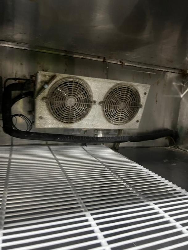 Commercial stainless steel 1-1/2 door refrigerated salad/sandwich prep table with poly-coated wired rack and casters.