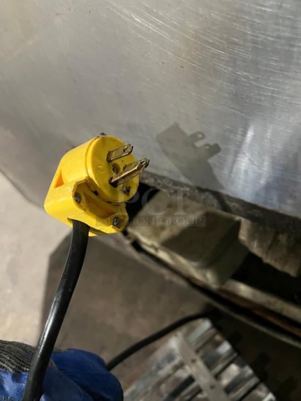 Commercial stainless steel refrigerated salad/sandwich prep table with poly coated wire rack, visible plug, on casters.