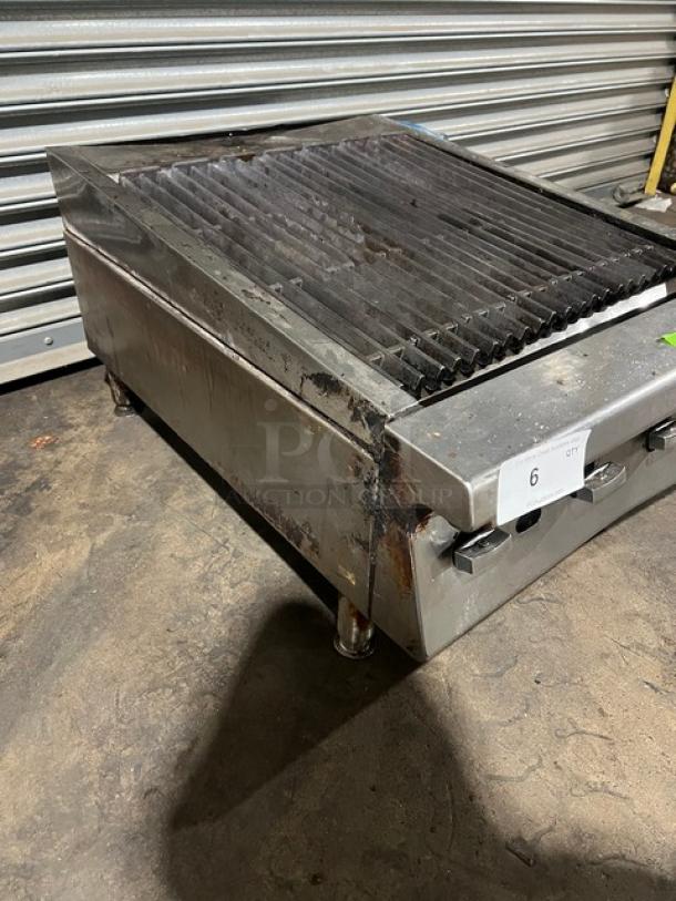 Garland commercial stainless steel gas countertop char broiler, on legs, with visible wear, auction tag "6".