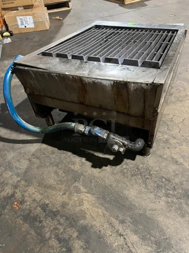 Garland stainless steel gas countertop char broiler on legs. Features durable construction, visible gas connection. Used condition.