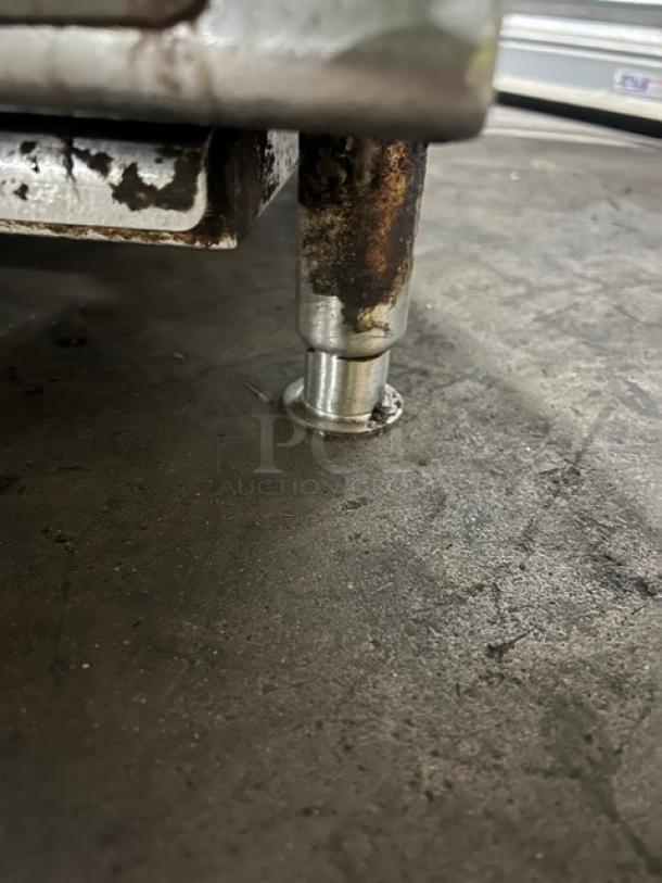 Garland stainless steel gas-powered countertop charbroiler leg detail, showing minor wear and sturdy construction.