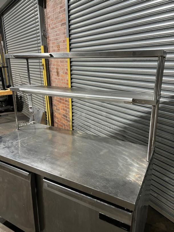 Continental SW60 stainless steel 2-door refrigerator with overhead shelf, ticket holder, poly-coated rack, on casters, model SN 15065218.