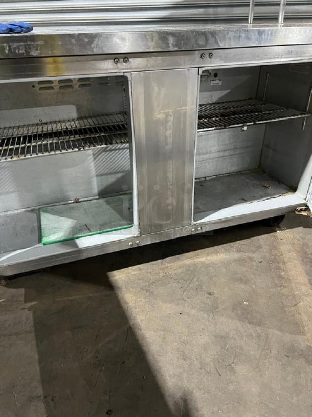 Continental SW60 stainless steel 2-door worktop refrigerator with double overhead shelf, poly coated wire rack, on casters.