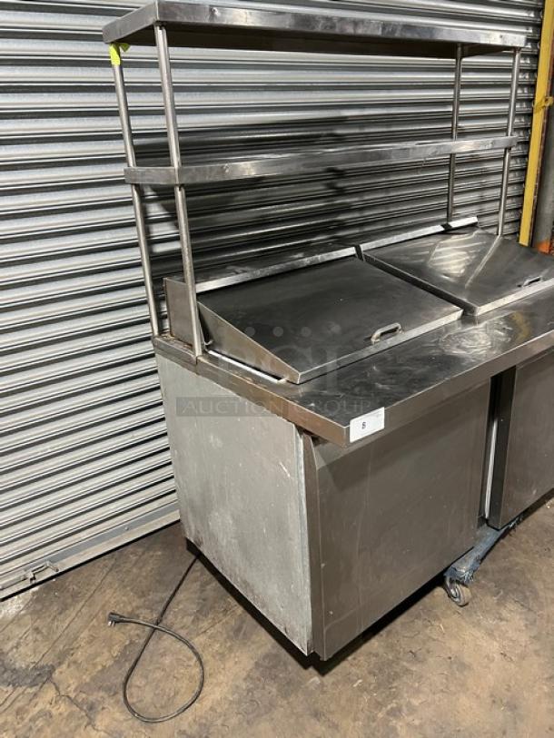 Continental SW60-24M refrigerated prep table with 2 doors, overhead shelf, and poly-coated wire rack. Stainless steel. 115V.