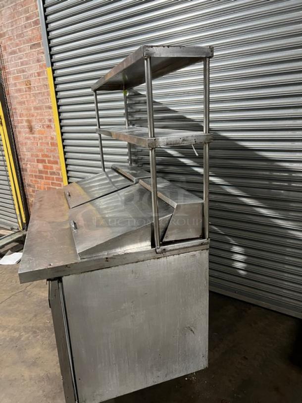 Continental SW60-24M refrigerated stainless steel prep table with double overhead shelf, poly-coated rack; used condition.