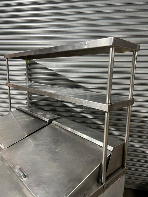 Continental SW6024M stainless steel prep table with two doors, double overhead shelf, poly-coated rack, excellent condition.
