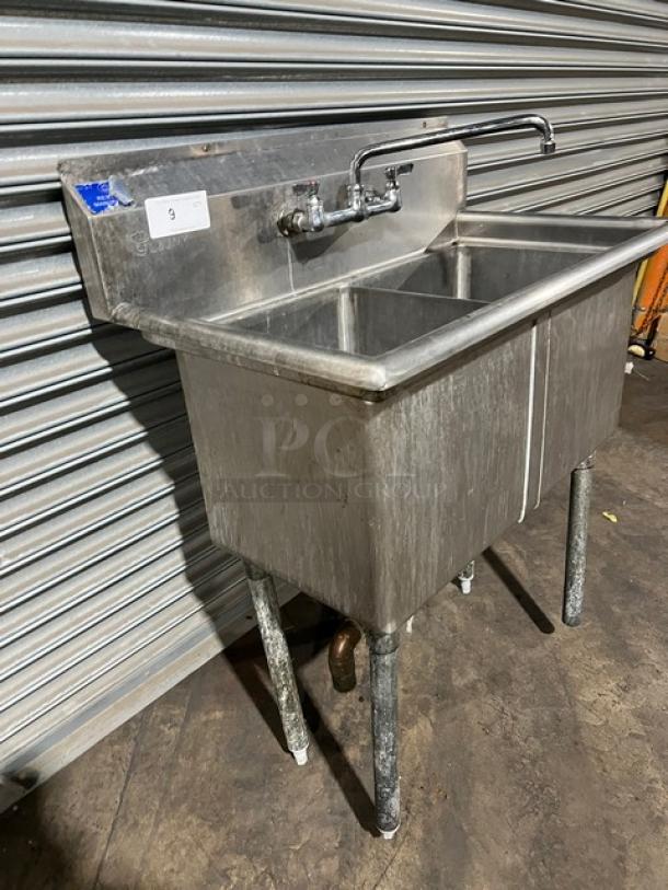L&J Commercial Stainless Steel 2-Compartment Prep Sink with swing spout swivel faucet, on sturdy legs. Slight wear visible.