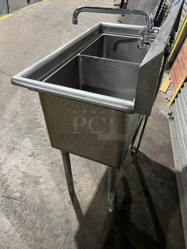 L&J stainless steel 2-compartment prep sink with swing spout swivel faucet, mounted on sturdy legs. Appears in good condition.