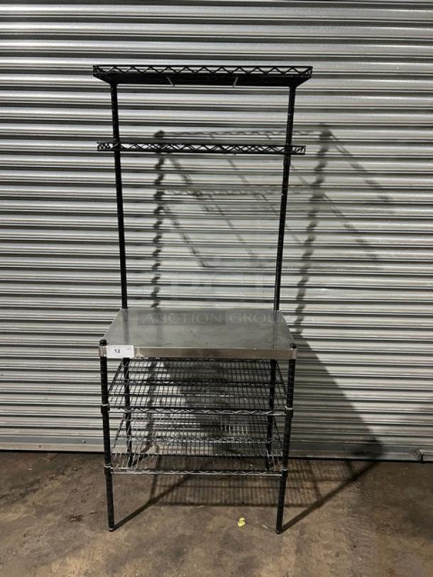 Commercial stainless steel worktop table with double wired rack shelves above and below. Excellent condition.