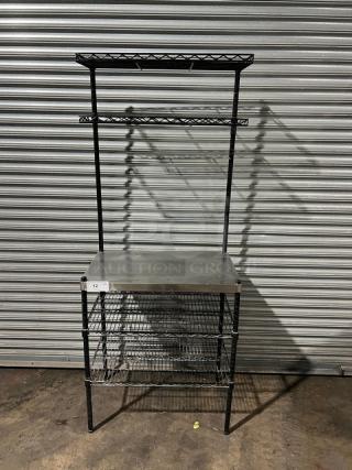 Commercial stainless steel worktop table with double wired rack shelves above and below. Excellent condition.
