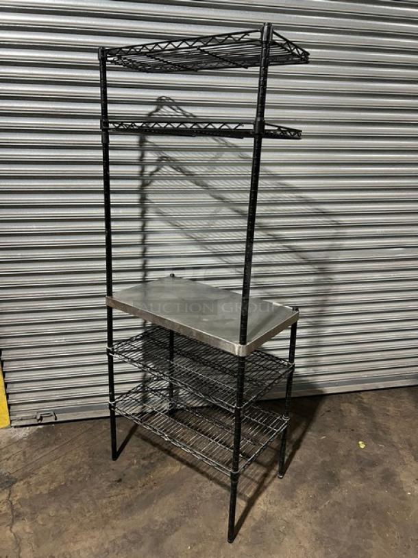 Commercial stainless steel worktop table with double wired racks above and below, on sturdy legs. Ideal for kitchen use.