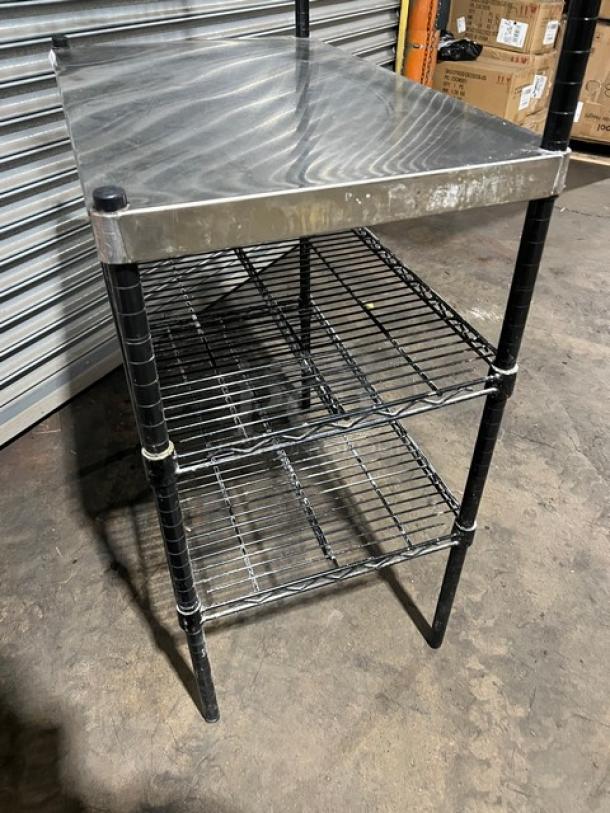 Commercial stainless steel worktop table with double wired racks, over and under shelves, on legs; used condition.