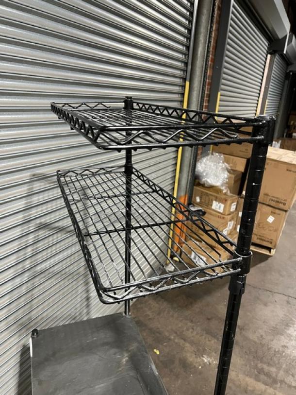 Commercial stainless steel worktop table with double wired shelves, both above and below. Mounted on sturdy legs. Ideal for industrial use.