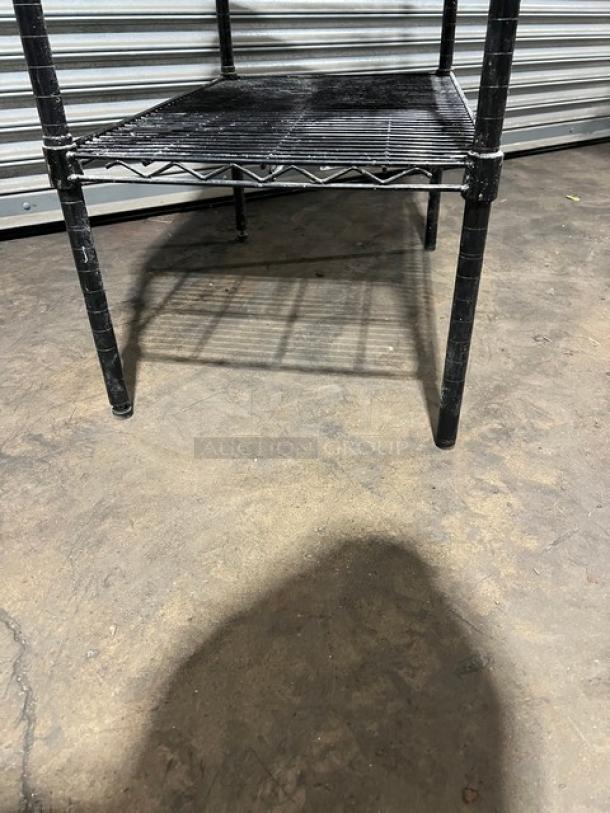 Commercial stainless steel worktop table with double wired rack shelves, on legs, minimal wear visible.