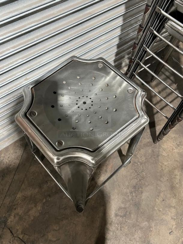 Stackable metal bar-height stool with perforated seat. Modern design, industrial finish, excellent condition. 5 available.