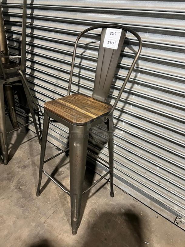 Stackable bar-height chair with metal frame and wooden seat. Industrial style, commercial-grade, good condition.