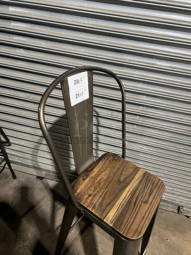 Stackable bar-height chair with metal frame and wooden seat. Features durable industrial design. Tags read "20" and "21."