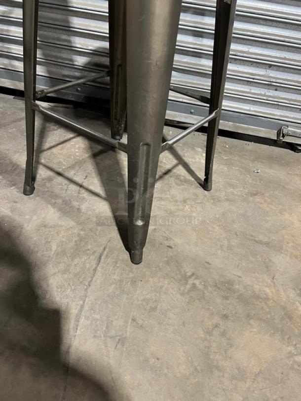 Commercial stackable bar-height chair, metal legs, durable, and slightly worn. Suitable for high-traffic settings.