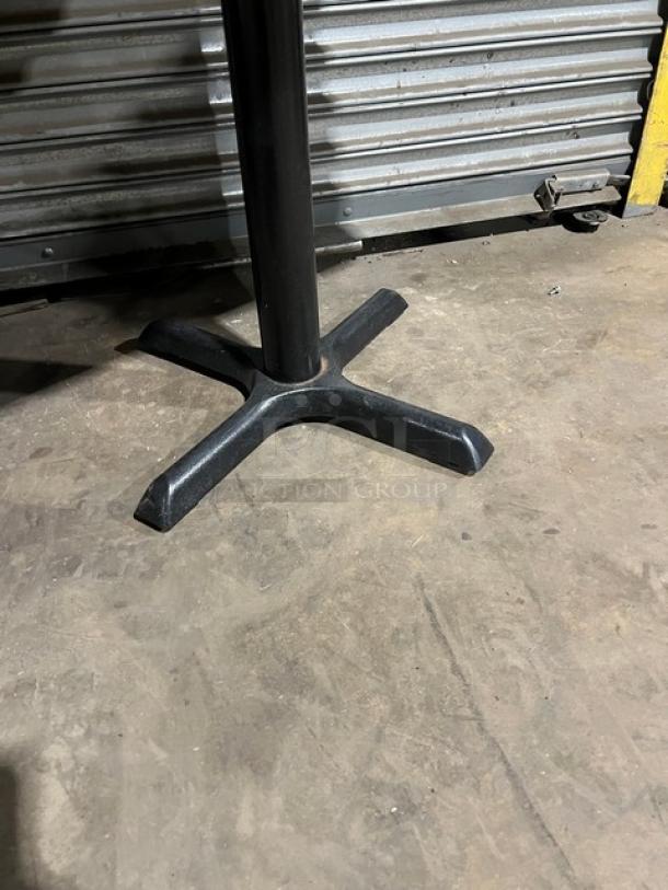 Commercial dining-height table base, metal construction, black finish, cross-shaped support, used condition.