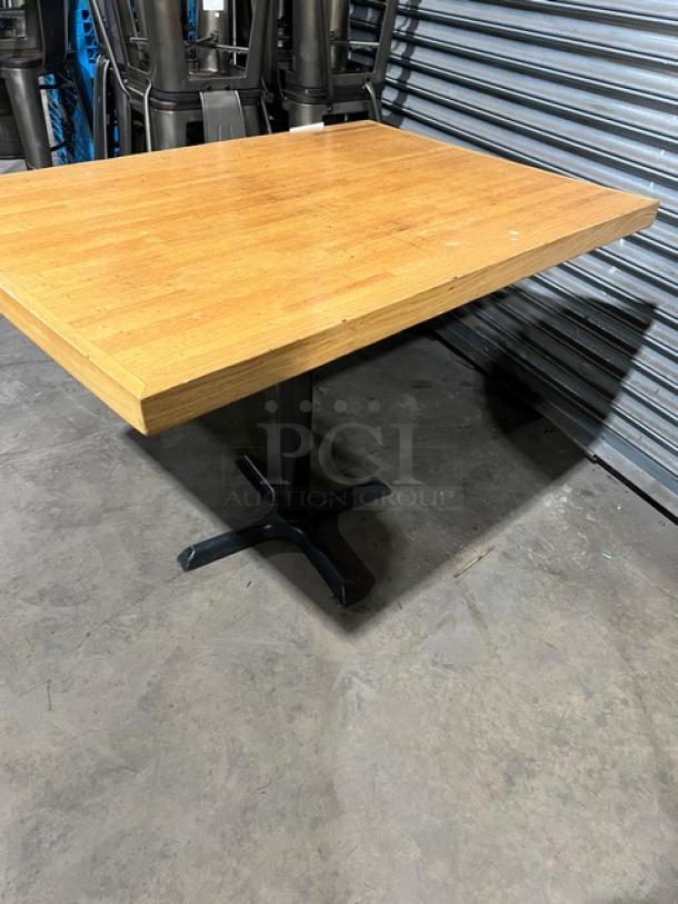 Commercial wooden rectangular tabletop with a sturdy pedestal base. Good condition. Ideal for restaurants or cafes.