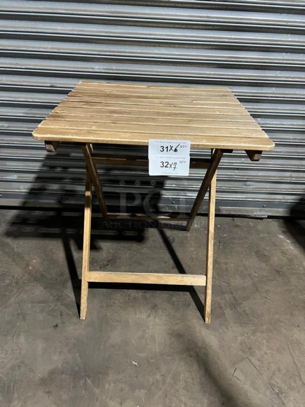 Commercial wooden folding table, sturdy build, natural finish. Dimensions and markings visible on attached tag.