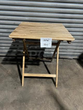 Commercial wooden folding table, natural finish, measures 31"x32". Tag indicates available quantity: 7 items.