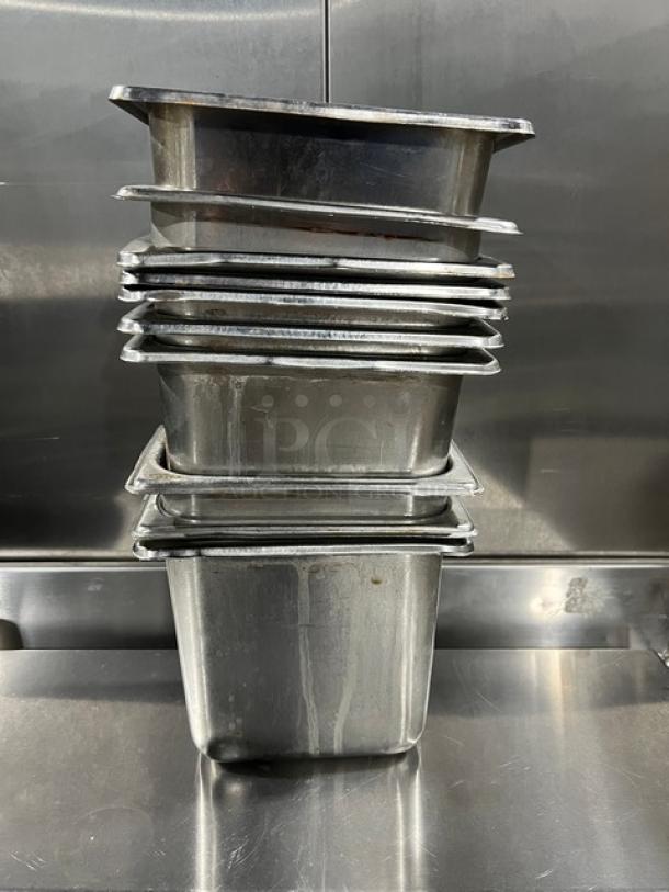 Commercial stainless steel hotel steamtable pans, stack of six, used condition, durable, perfect for catering or restaurants.