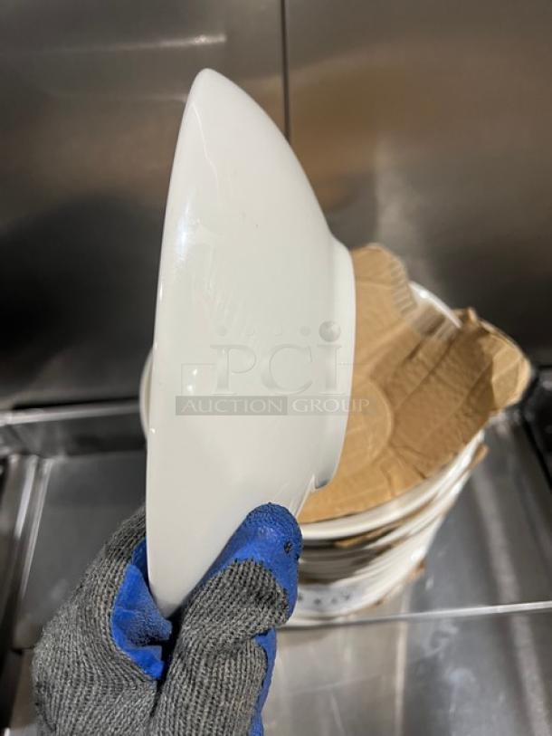 Anfora Commercial white round bowl in pristine condition, smooth finish, stackable design, shown held next to shipping materials.