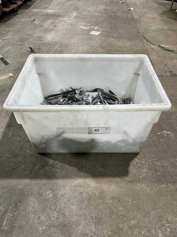 Commercial stainless steel dining utensils in a large white bin. Contains forks, knives, and spoons. Labeled "42".