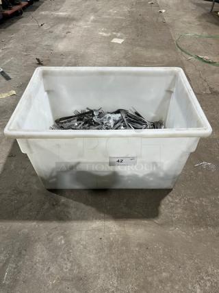 Commercial stainless steel dining utensils in a large white bin. Contains forks, knives, and spoons. Labeled "42".