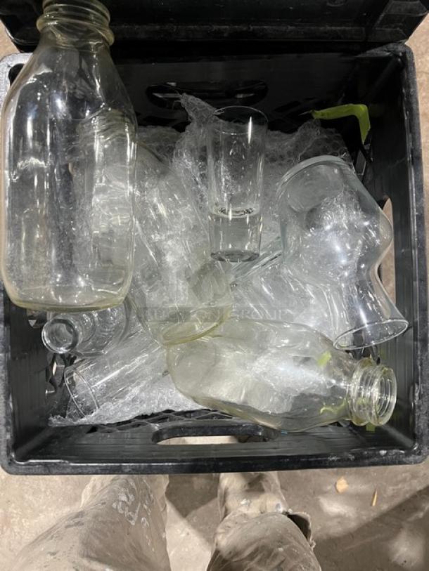 Alt text: Crate of commercial glass bottles for water or juice, wrapped in bubble wrap, good condition, part of 8-crate set.