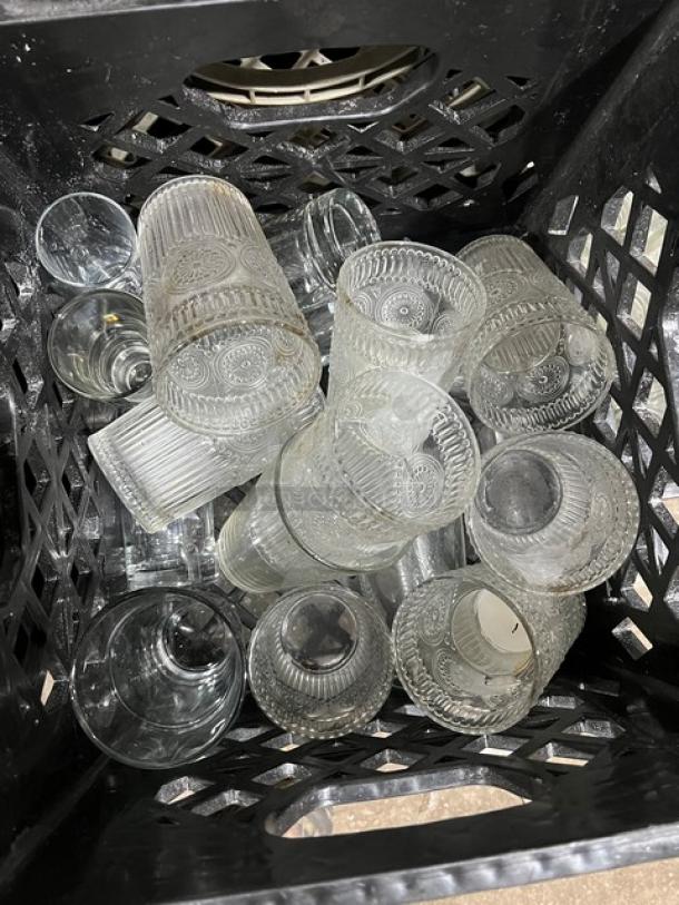 Commercial water/juice serving bottles in crate. Includes 8 crates total. Glassware is patterned and in used condition.