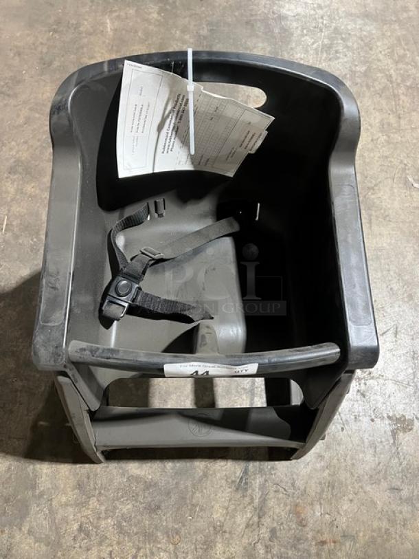 Rubbermaid Commercial black restaurant highchair, model FG780608BLA, on casters, with safety strap and attached tag.