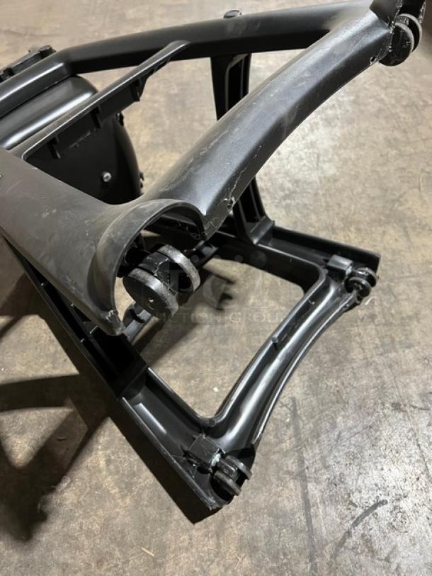 Rubbermaid Commercial black restaurant highchair base, model FG780608BLA, with casters, showing wear on frame.