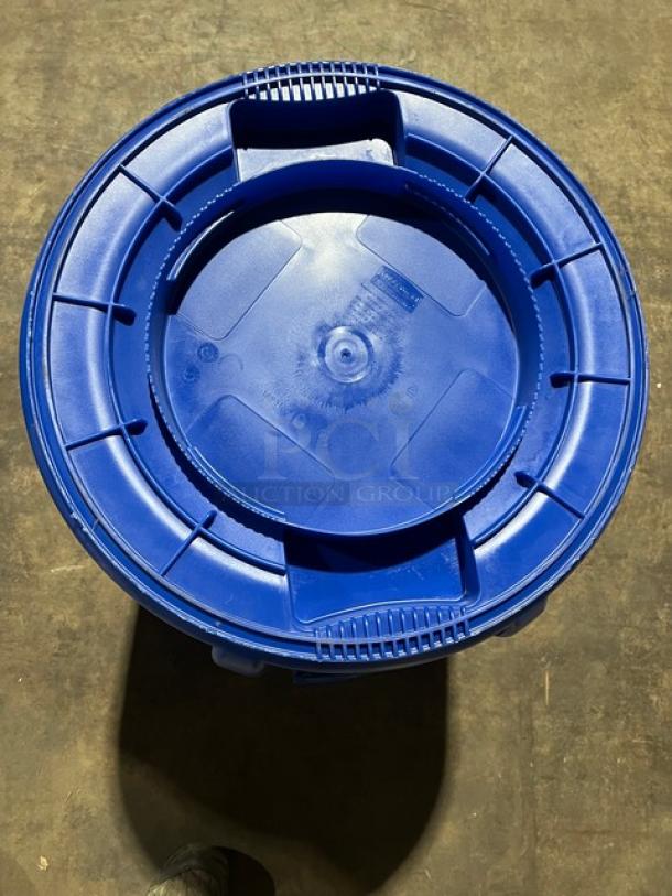 Rubbermaid Brute Series blue 32-gallon round trash can, new condition. Durable commercial design, top view shown.