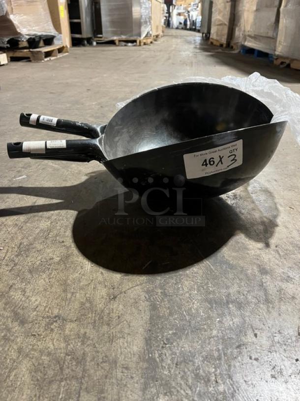 Commercial black non-stick frying pans with ergonomic handles stacked together. Label indicates "46 x 3 qty." Ideal for kitchen use.