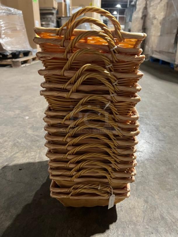 Stack of 17 woven display baskets with handles. Natural material, excellent condition. Ideal for retail or decorative use.