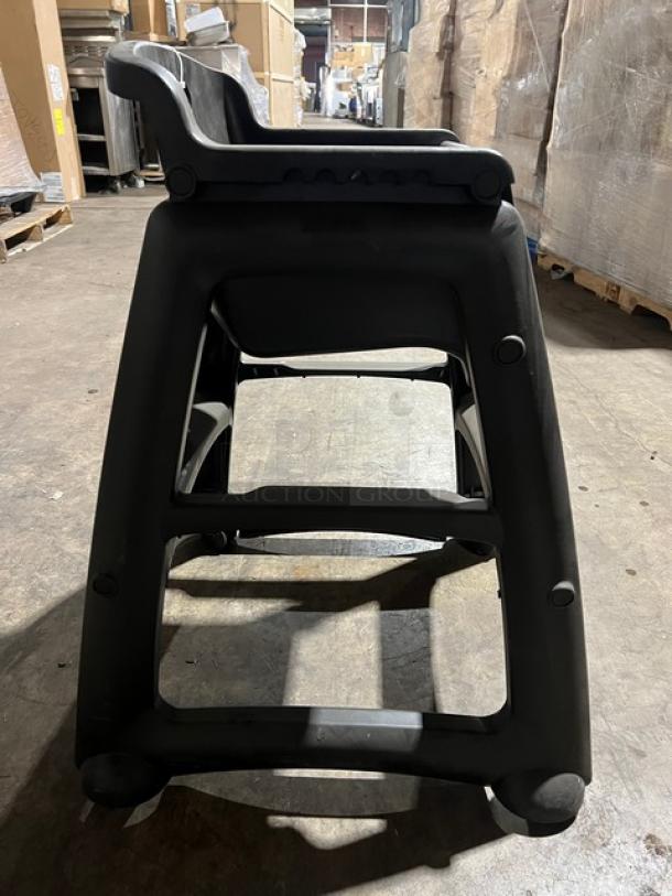 Rubbermaid Commercial black restaurant highchair on casters, durable plastic, excellent condition.