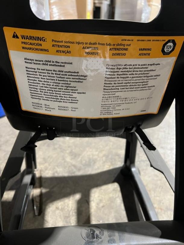 Rubbermaid Commercial black restaurant highchair on casters, features safety warning labels, used condition.