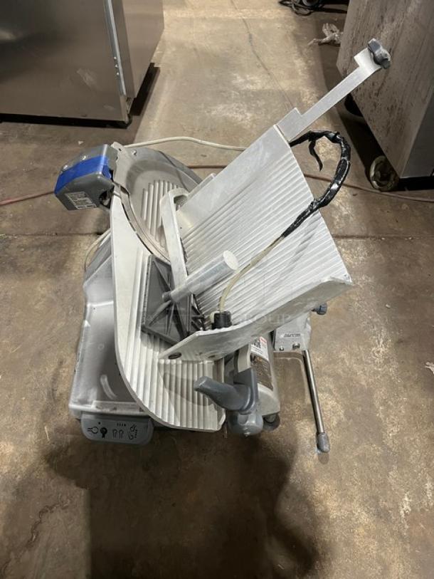 Hobart commercial electric deli meat slicer, heavy-duty, countertop model, used condition, visible control labels, robust construction.