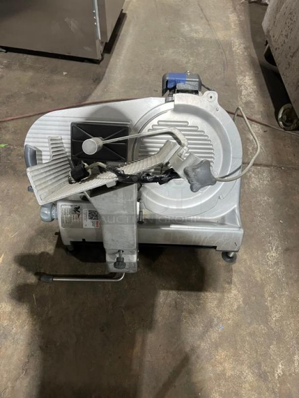 Hobart commercial electric deli meat slicer, countertop model, heavy-duty, used condition, visible power cord and safety guard.
