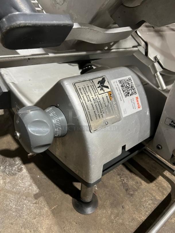 Hobart heavy-duty deli meat slicer, electric-powered, countertop model, visible safety labels.