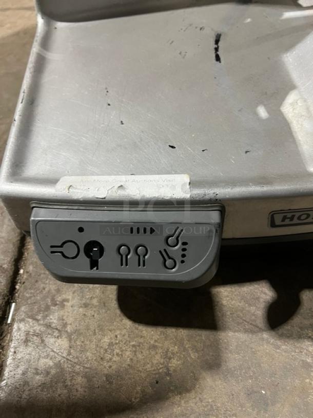 Hobart commercial electric deli meat slicer, countertop model, heavy duty. Visible controls and wear on metal surface.