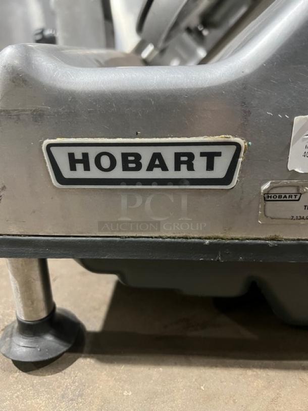 Hobart commercial electric deli meat slicer, heavy-duty, stainless steel, countertop design, visible brand label, good condition.